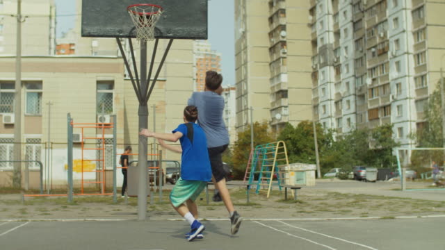 Teenage-streetball-players-playing-one-on-one-game