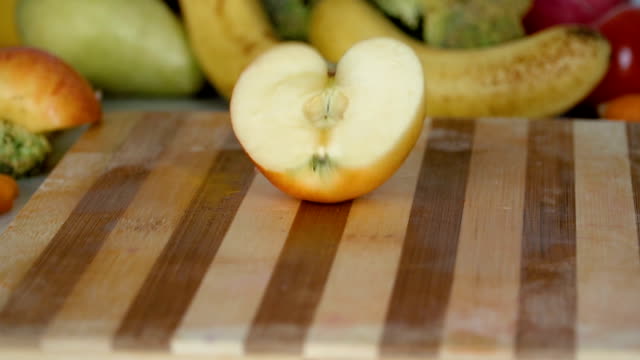 Apple-slices-fall-on-cutting-board-in-slow-motion