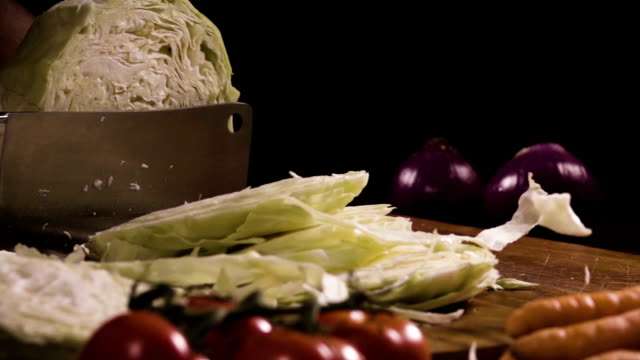 Cutting-cabbage-with-knife-on-the-wood.-Slow-motion-240-fps