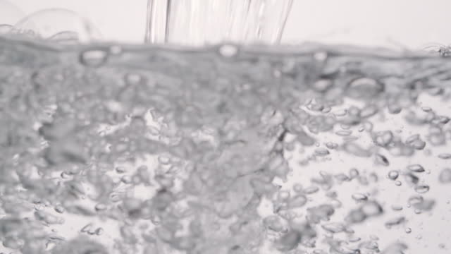 Stream-of-Pouring-Water-Causing-Bubbles-Under-Surface