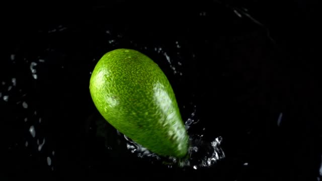 avocado-on-a-black-background.-Slow-motion.