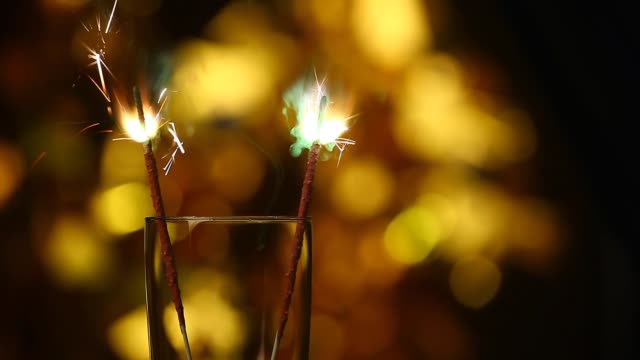empty-champagne-glass-Bengalese-candle-gold-bokeh