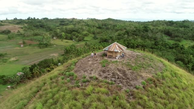 Aerial-view-couple-on-the-top-of-Chocolate-Hills-Complex,-Batuan,-Philippines.