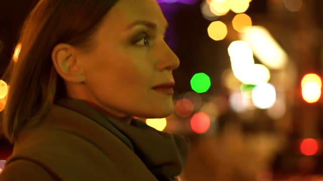 Beautiful-successful-woman-walking-on-night-city-street,-megalopolis-rush-hour