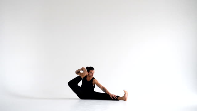 Man-practicing-intense-yoga-asana