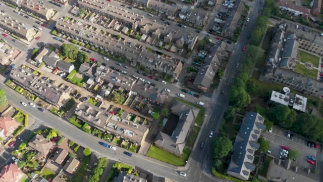 Aerial-footage-of-the-Leeds-town-of-Pudsey-in-West-Yorkshire,-England-showing-typical-British-streets-and-business-taken-on-a-sunny-bright-summers-day.