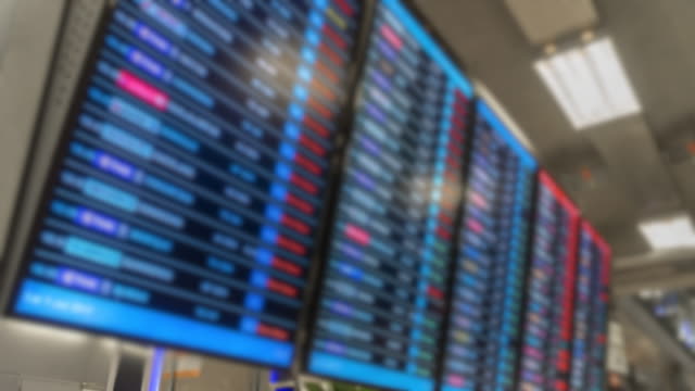 Time-lapse-blur-Air-passengers-Checking-Suvarnabhumi-Airport-departure-screens