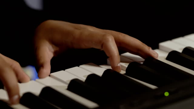 Male-hands-plays-melody-on-piano