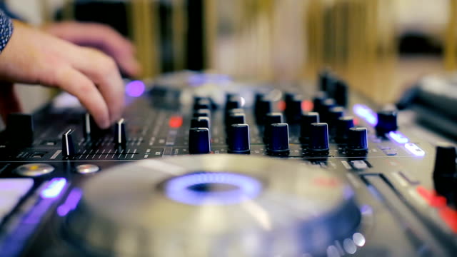 Hände-von-einem-DJ-mischen-auf-den-professionellen-Controller
