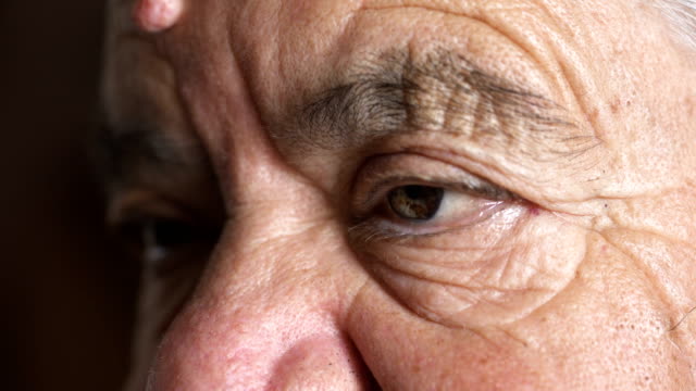 Close-up-on-wrinkled-eyes-of-sad-old-woman