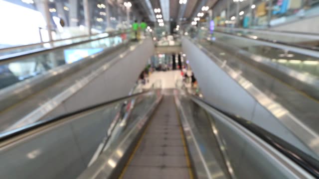 Blur-View-From-people-moving-escalator-In-airport-gate,-moving-standing-on-sidewalk.-Defocused-footage