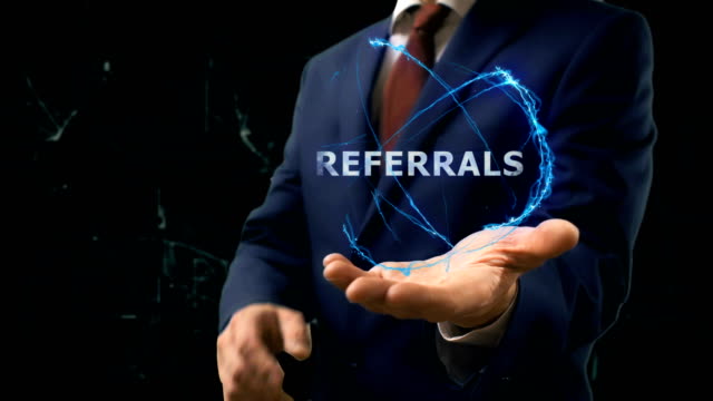 Businessman-shows-concept-hologram-Referrals-on-his-hand