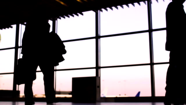 Silhouettes-of-busy-people-in-main-hall-of-airport,-illegal-immigration-problems