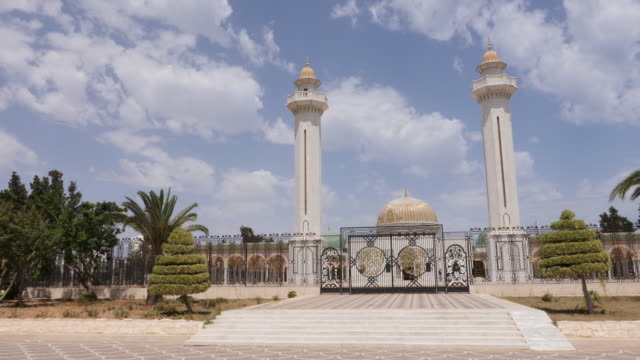 Gate-at-entrance-to-mausoleum-Habib-Bourguiba-with-golden-dome-in-Monastir-city.-Outdoors-dolly-shot