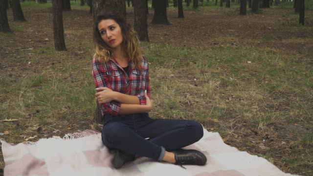Sad-young-girl-is-sitting-in-the-forest