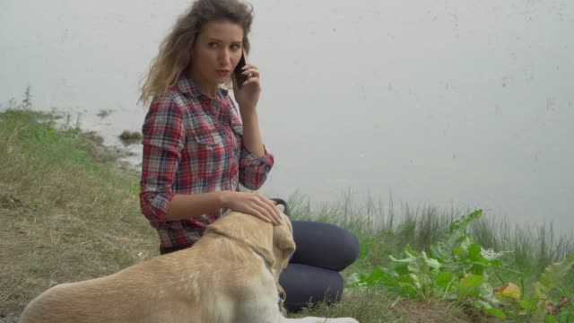 Pretty-woman-and-dog-is-resting-outdoor-together