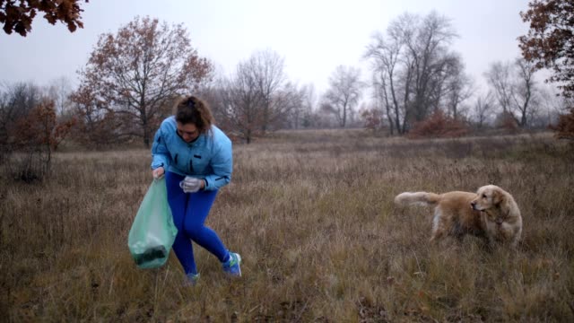 Eco-friendly-woman-picking-up-litter-outdoors