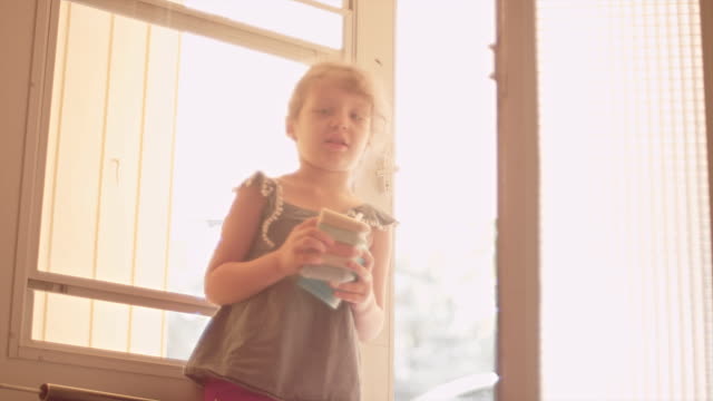 A-little-girl-holds-open-a-screen-door-and-her-dog-accidentally-gets-out
