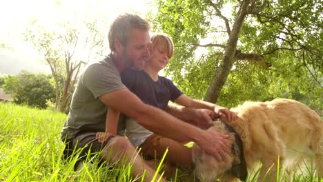 Dad-plays-with-his-cute-son-and-their-dog-outside