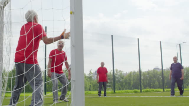 Pensioner-Catching-Football-at-Goal-Net