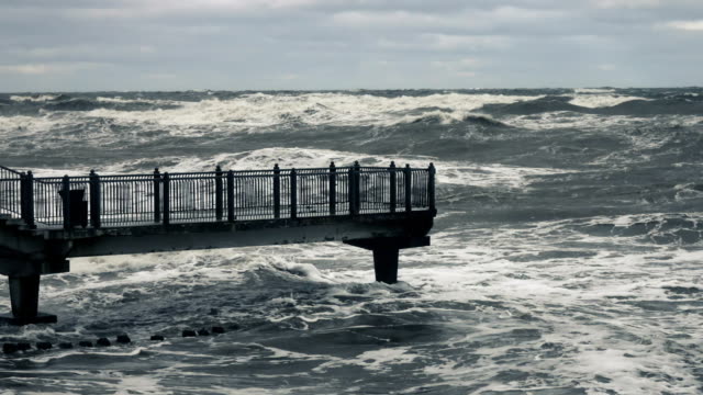 High-wave-breaking-on-the-rocks-of-the-coastline.-Stormy-weather-on-sea-with-big-wave-breaking-on-breakwater.