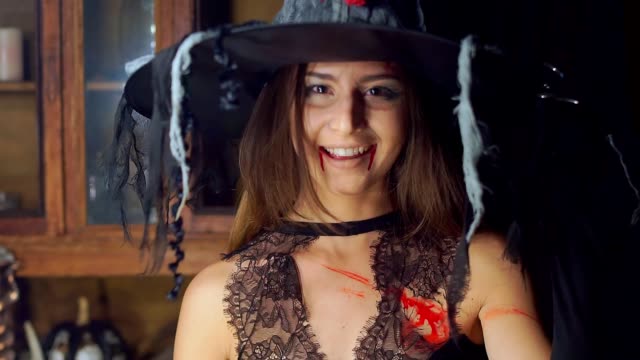 Halloween-witch-raises-her-head-from-under-the-hat-angrily-laughing