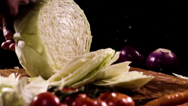 Cutting-cabbage-with-knife-on-the-wood.-Slow-motion-480-fps