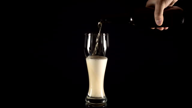 pouring-beer-in-a-beer-glass-on-a-black-background