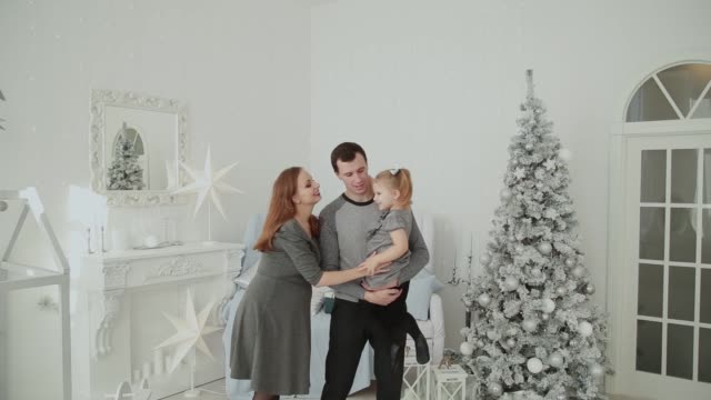Familia-muy-feliz-riendo-y-jugando-en-la-habitación-de-Navidad
