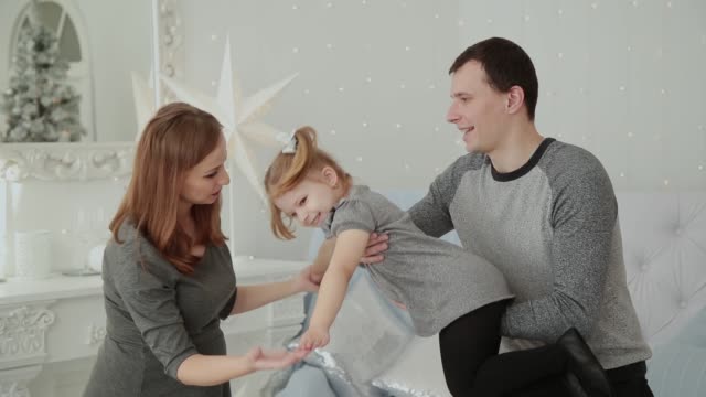 Familia-muy-feliz-riendo-y-jugando-en-la-habitación-de-Navidad