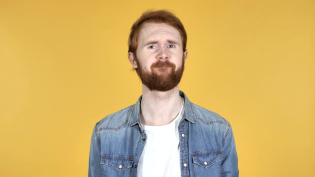 Redhead-Man-Shaking-Head-to-Reject-Isolated-on-Yellow-Background