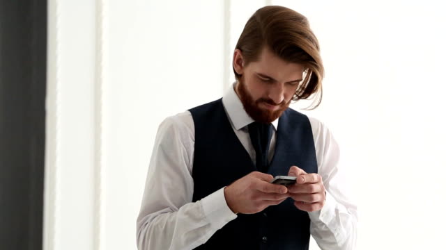 Bearded-man-using-his-smart-phone.