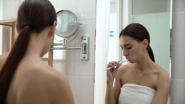 Dental-Health.-Woman-Brushing-Teeth-In-Bathroom