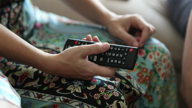 Hand-holding-TV-remote-control