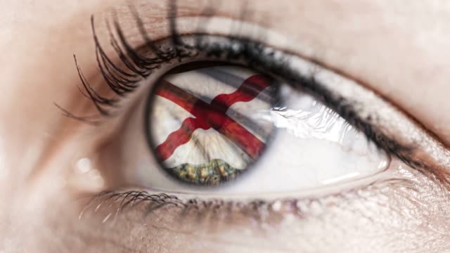 Woman-green-eye-in-close-up-with-the-flag-of-Alabama-state-in-iris,-united-states-of-america-with-wind-motion.-video-concept