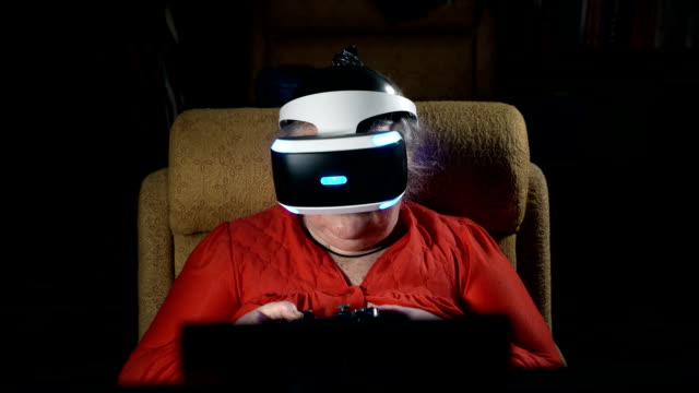 Anciana-delante-de-pantalla-utiliza-VR-auriculares-y-controlador-de-juegos-inalámbrico