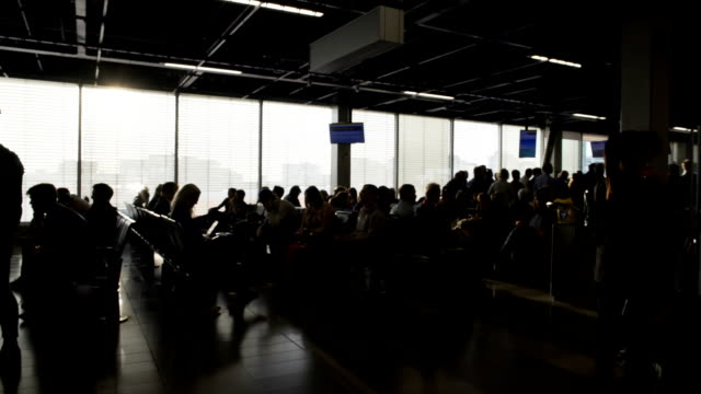 Passengers-sitting-at-departure-lounge-and-waiting-for-boarding,-terminal