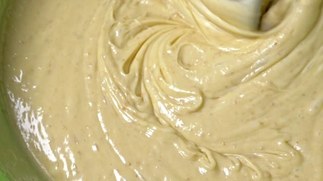 Mixing-the-dough-with-a-mixer.-Cooking-of-cream-dough-with-a-mixer,-slow-motion-shooting-in-180fps.-Beautiful-waves-on-a-thick-liquid.-Standard-dough-for-cupcakes.
