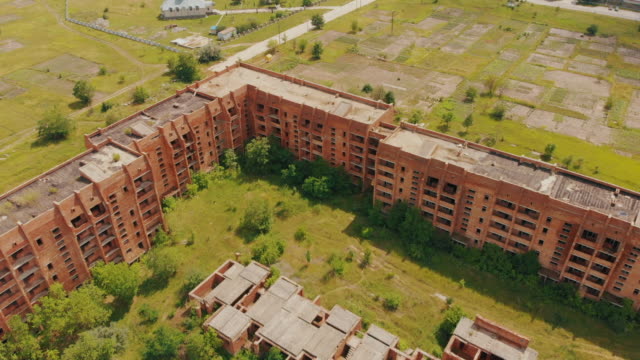 Flying-above-old-abandoned-construction.-AERIAL:-Flight-over-unfinished-high-rise-building-with-apartments.-Drone-view.-Summer-season.-Abandoned-city-after-disaster.-HD-footage