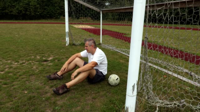 Disappointed-soccer-goalkeeper-at-the-soccer-football-field-gates