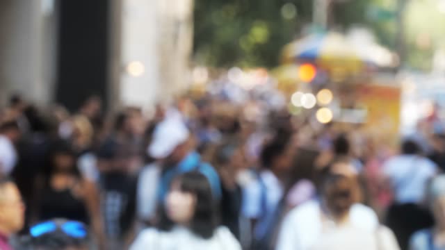 Crowd-of-people-walking-on-busy-city-street-out-of-focus