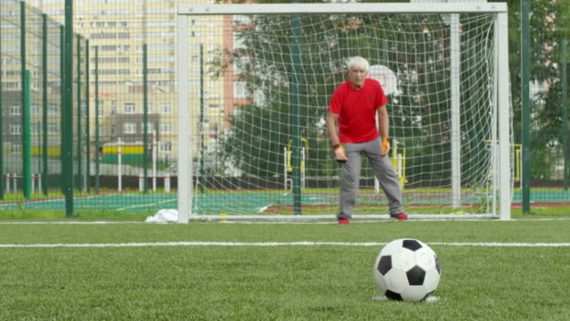 Senior-Male-Friends-Playing-Football