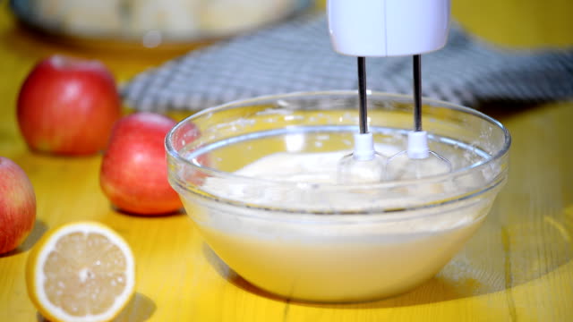 Electric-mixer-beats-mass-of-batter-in-the-kitchen.-Making-apple-cake