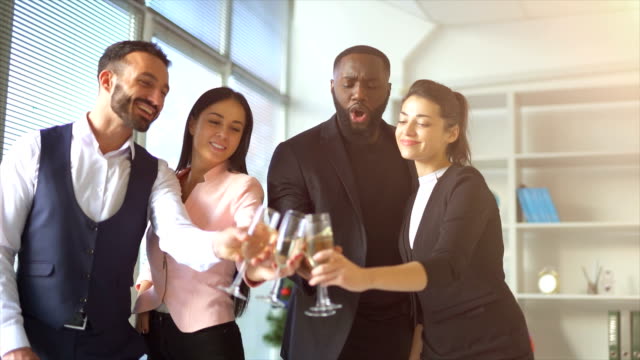 The-four-business-people-drinking-alcohol-in-an-office.-slow-motion