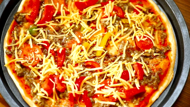 homemade-pizza-with-forest-mushrooms,-peppers-and-tomatoes
