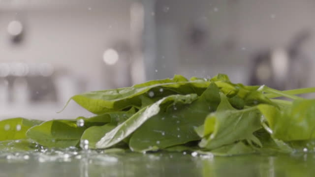 Falling-of-spinach-into-the-water.-Slow-motion-480-fps