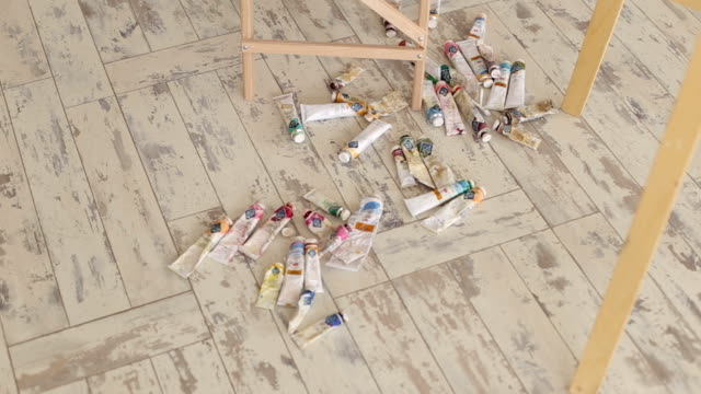 Many-multi-colored-tubes-with-oil-paint-for-drawing-on-a-wooden-surface.