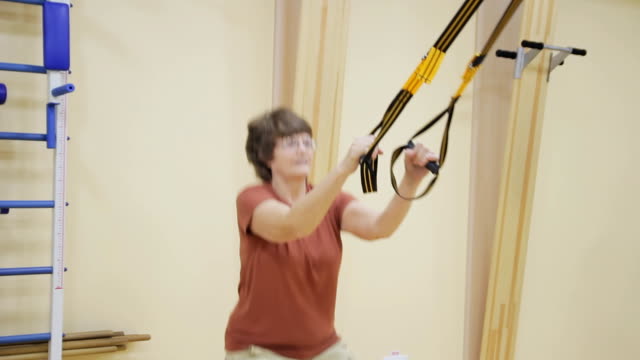 Senior-woman-doing-exercises-in-fitness-room.