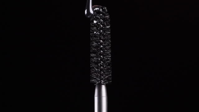 drops-of-black-mascara-fall-on-the-brush-on-a-black-background-2