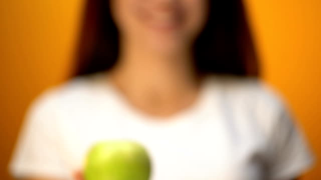 Woman-holding-green-apple,-concept-of-slimming-and-healthy-diet,-vitamin-closeup